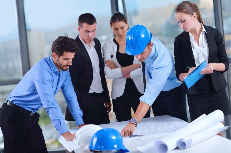 business people group on meeting and presentation  in bright modern office with construction engineer architect and worker looking building model and blueprint  plans