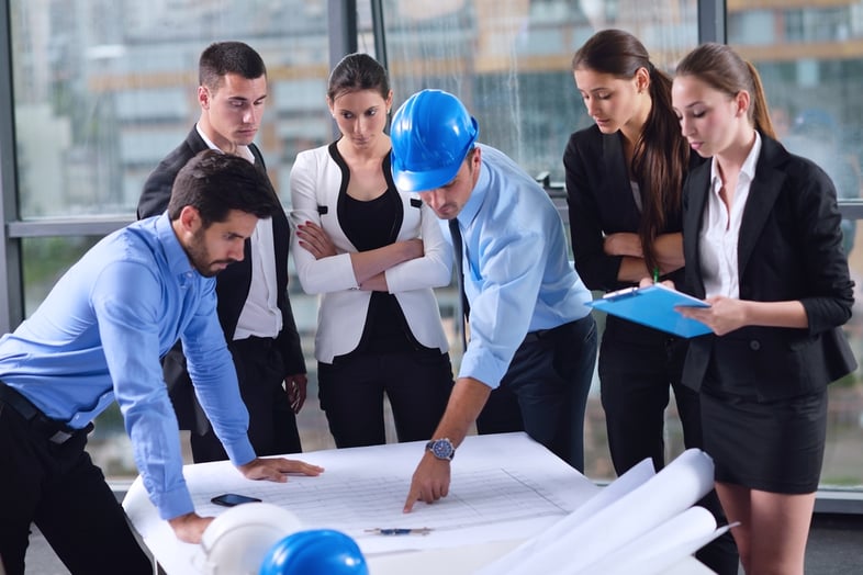 business people group on meeting and presentation  in bright modern office with construction engineer architect and worker looking building model and blueprint planbleprint plans-1